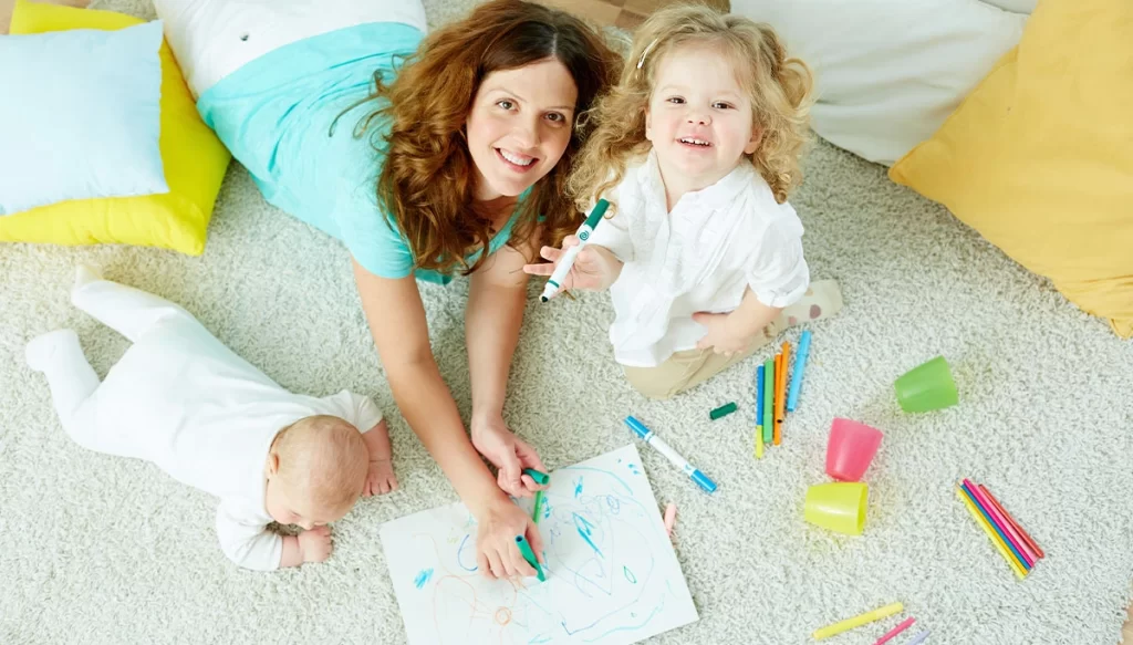 mother and children with a coloring book