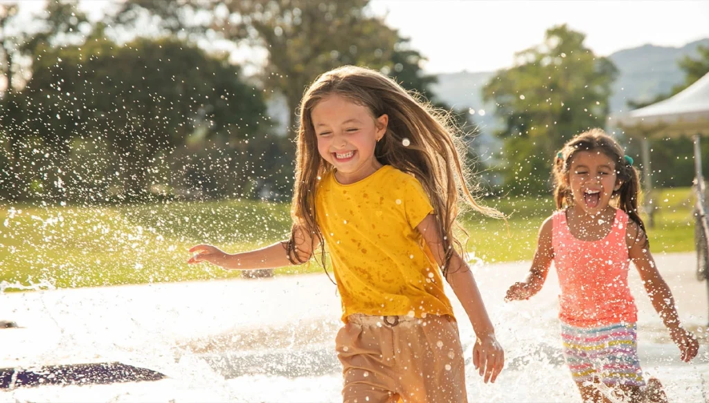 girls playing in a puddle