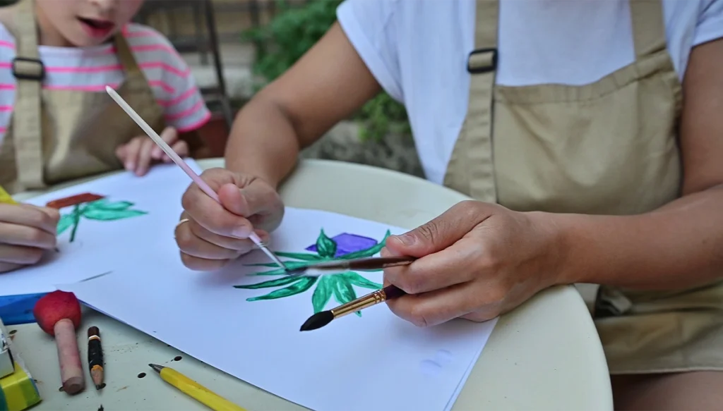 children painting plants on paper