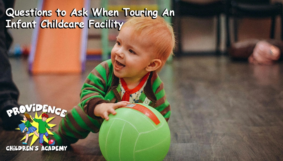Infant playing with a ball in a classroom