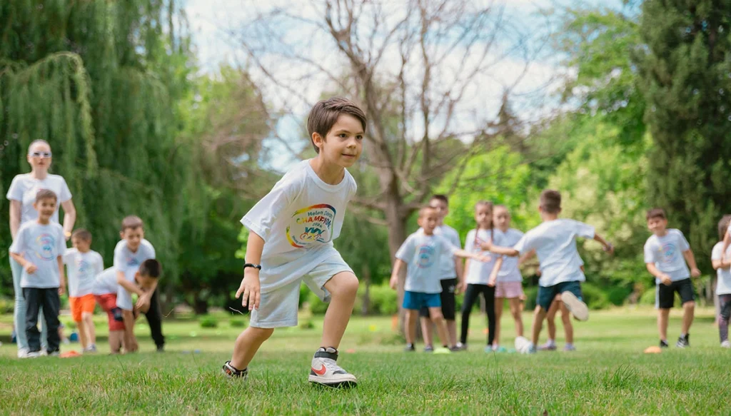 A group of children actively playing with hula hoops on a bright summer day in the park.