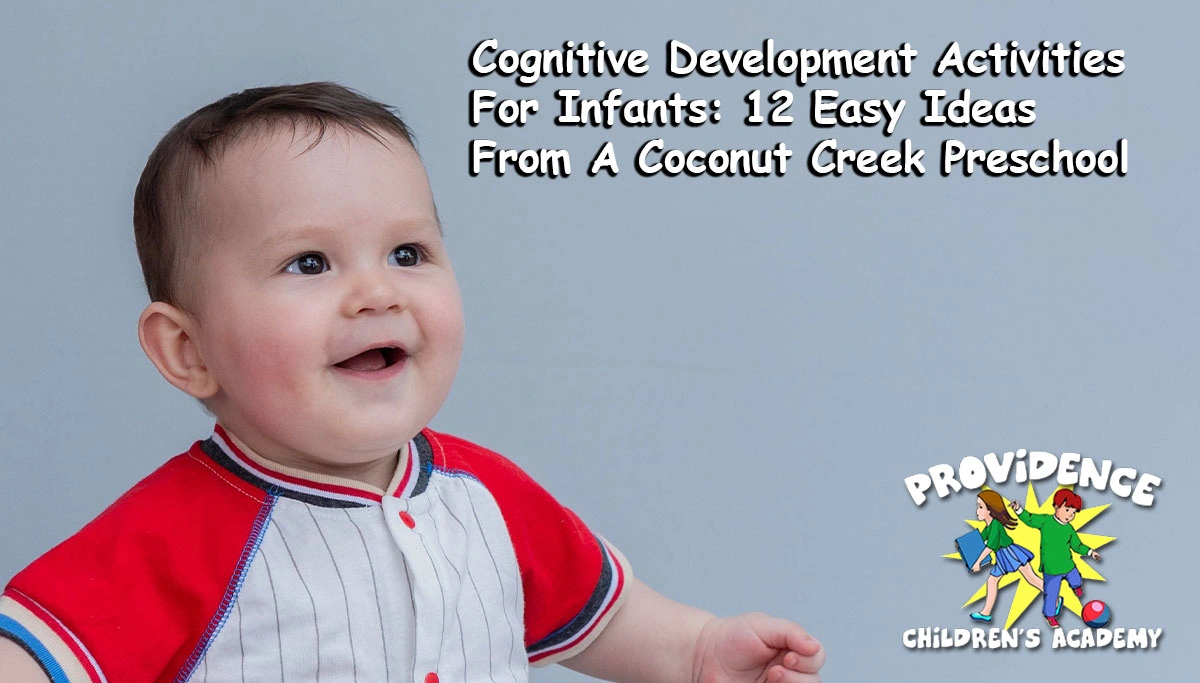 baby sitting and smiling in a sporty red and white outfit against a light blue background