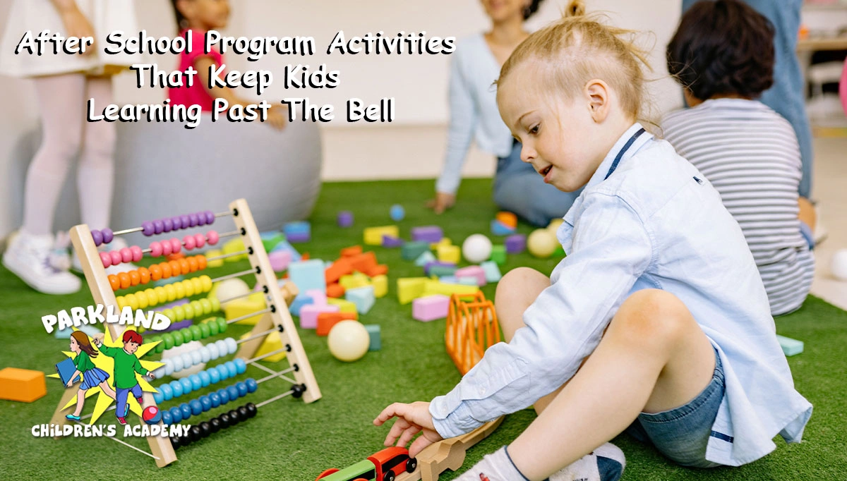 young girl playing with an abacus and small toys on a fake grass floor